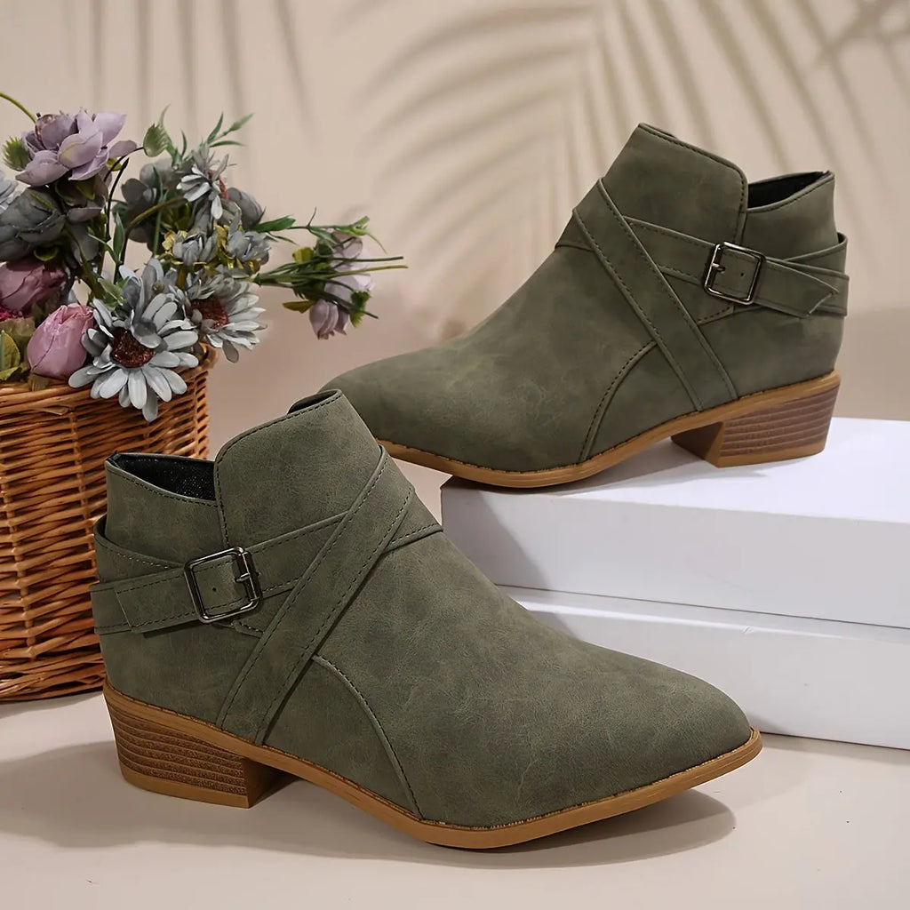 Close-up of faux suede texture on olive block heel boots.