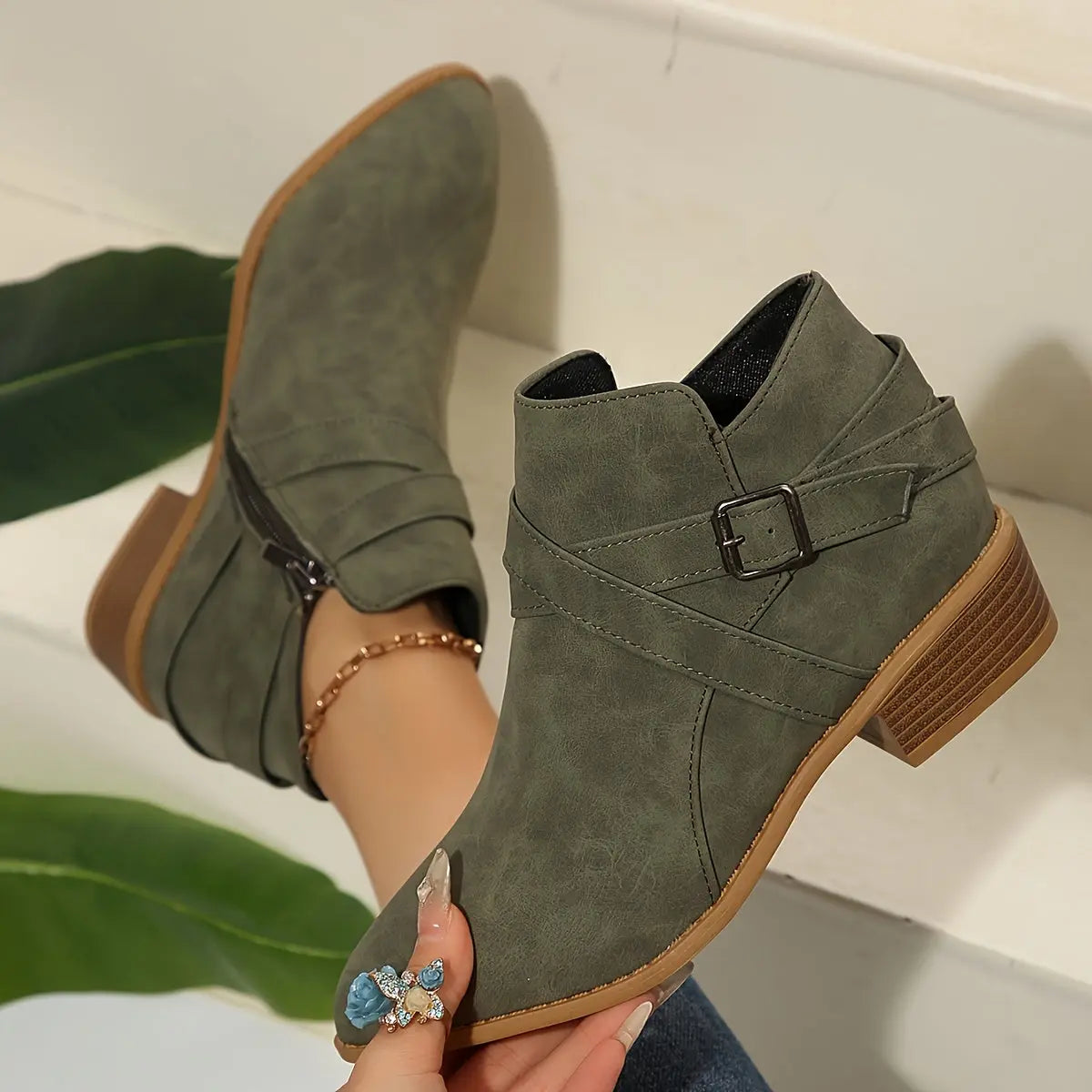Olive block heel boots with faux suede finish and pointed toe design.