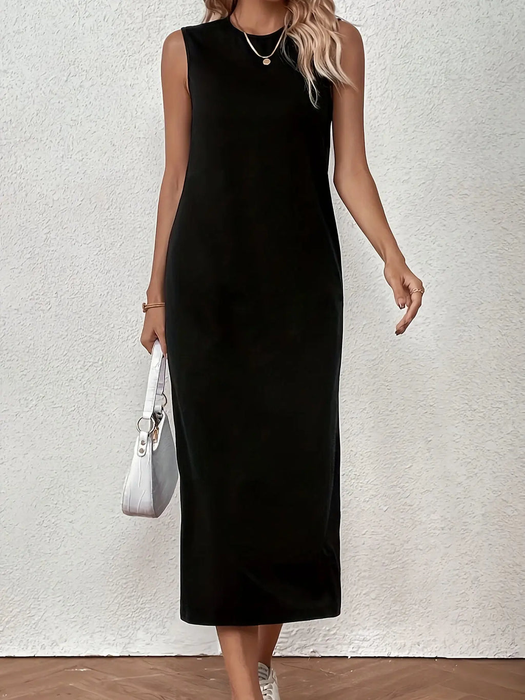 Midnight Whisper Maxi dress in black, showcasing a flowing silhouette and sleeveless design.