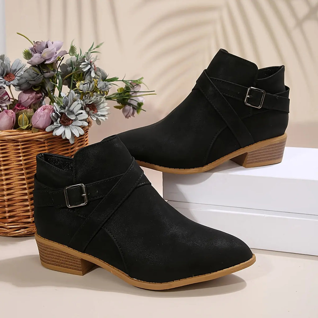 Olive block heel boots on cobblestone street, highlighting all-day comfort.