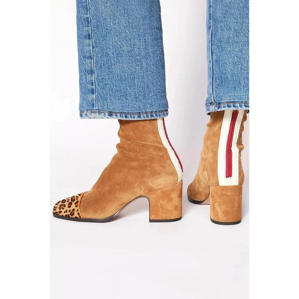 Fashion-forward black ankle boots showcasing a block heel and easy zipper for effortless wear.