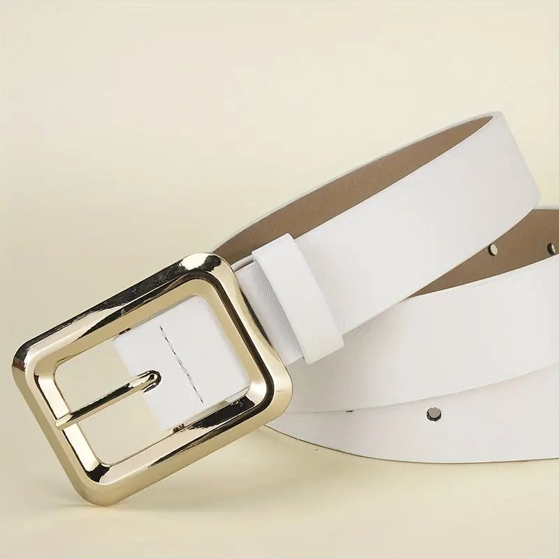Golden buckle belt draped around a flowing dress, showcasing elegance.