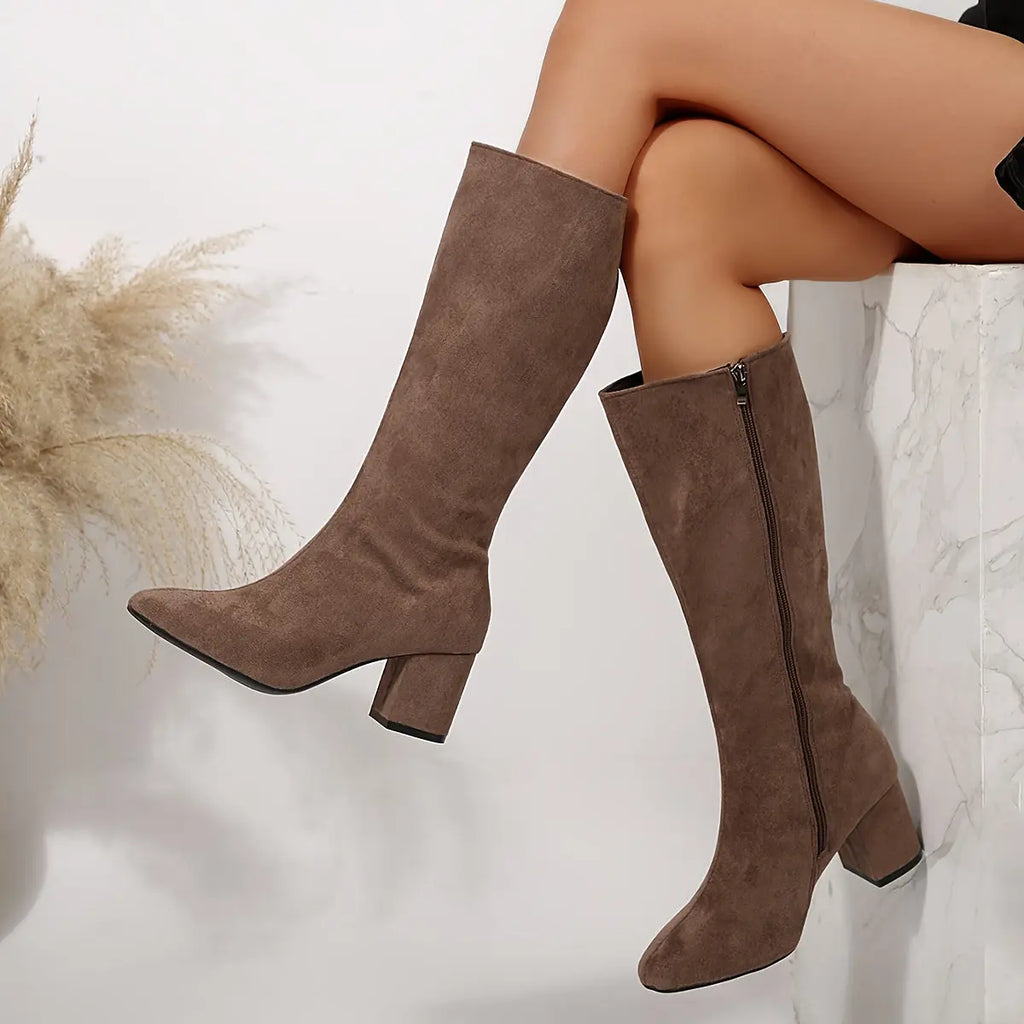Close-up of the sleek zipper closure on stylish over-the-knee boots.
