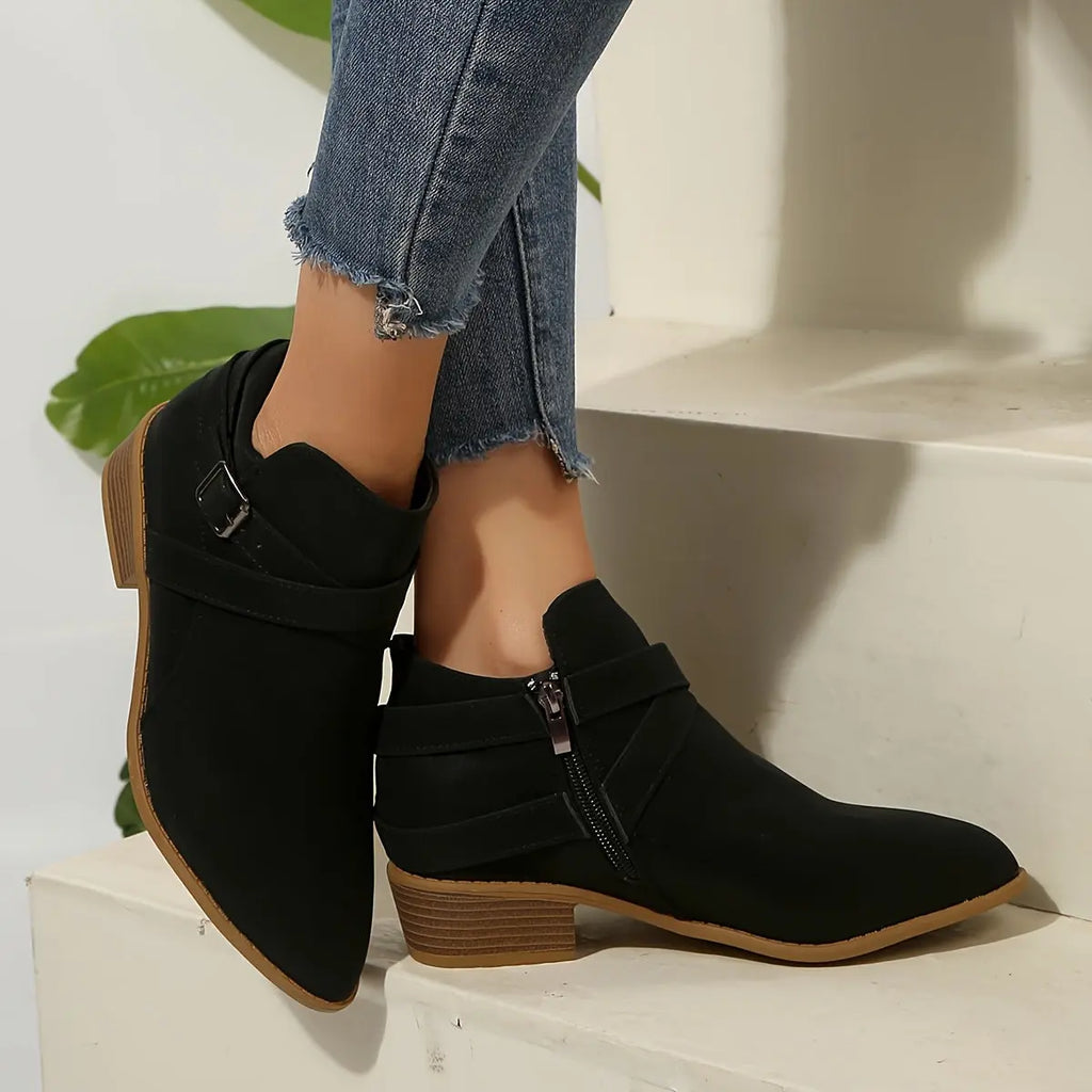 Stylish olive block heel boots displayed on a wooden surface.