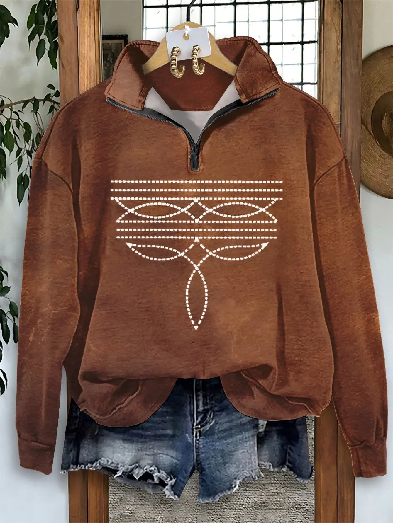 Stylish brown hoodie with unique chain detail, perfect for autumn fashion and casual wear.