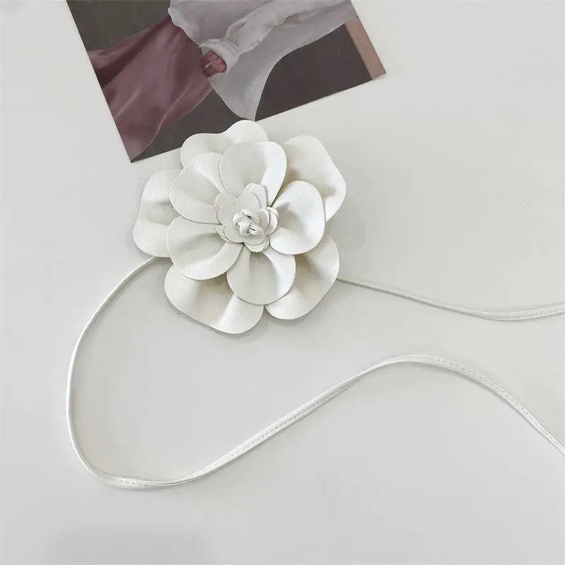 Floral PU belt with decorative flower, perfect for cinching your silhouette.
