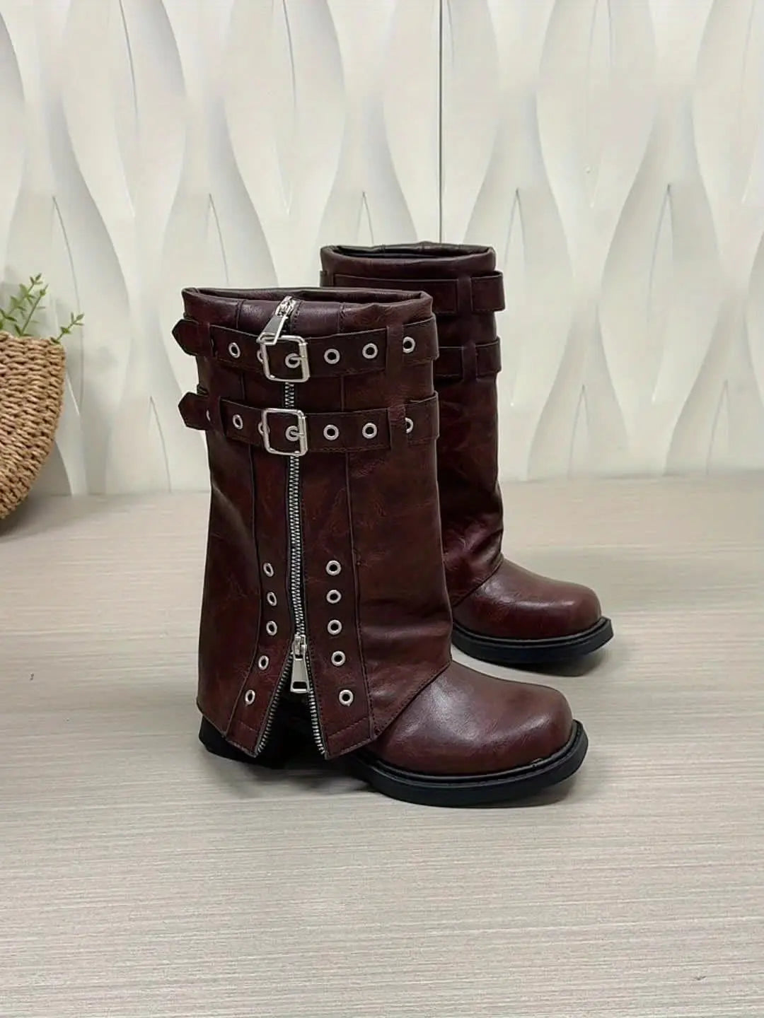 Winter Whispers boots displayed on a wooden surface, emphasizing their rich color.