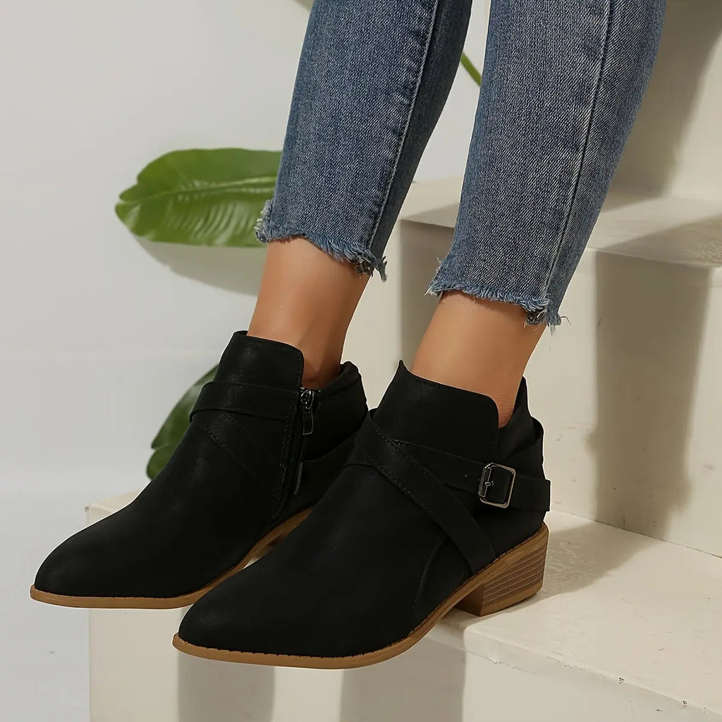 Back zipper closure of olive block heel boots for easy wear.
