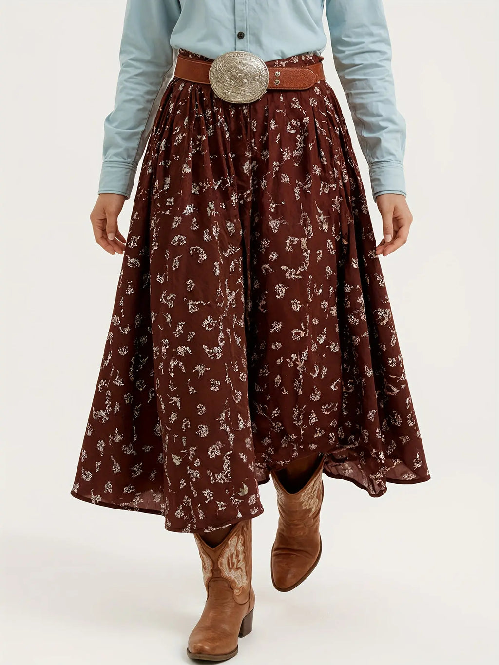 Model twirling in a floral denim skirt, showcasing its soft polyester blend and vibrant colors in an autumn setting.
