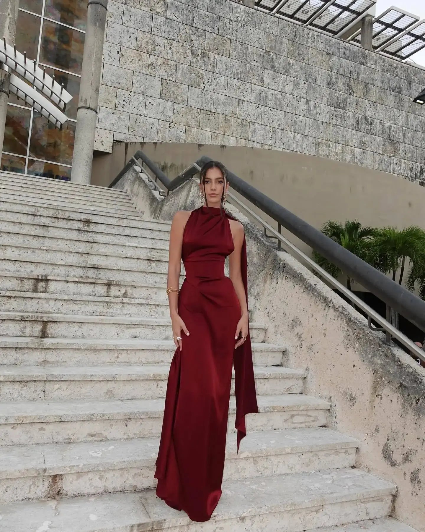 Full-length satin gown in burgundy, perfect for cocktail parties and weddings.