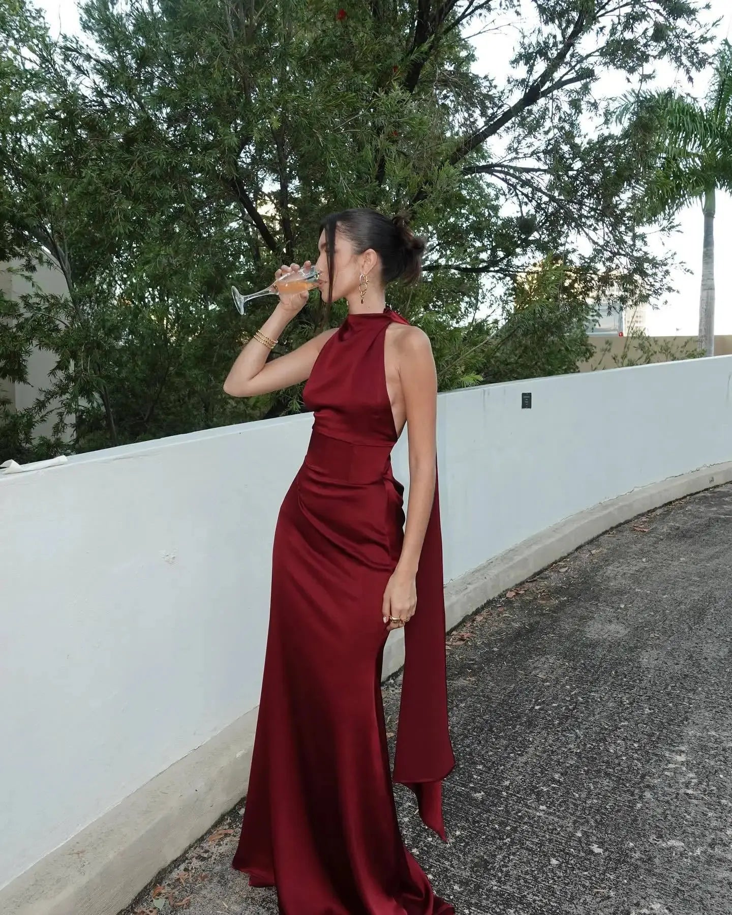 Backless burgundy dress showcasing luxurious satin fabric and elegant silhouette.
