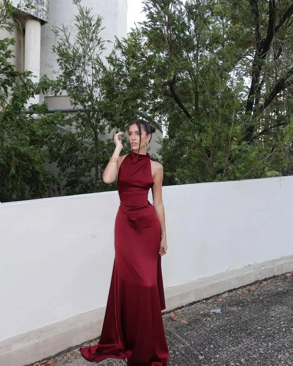 High-waist corset design enhances figure in this stunning burgundy satin gown.