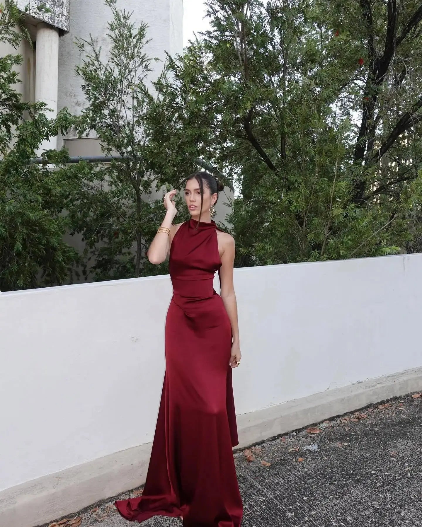 High-waist corset design enhances figure in this stunning burgundy satin gown.