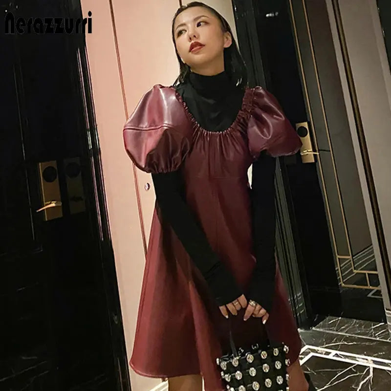 Close-up of synthetic leather texture on luxe lantern sleeve dress.