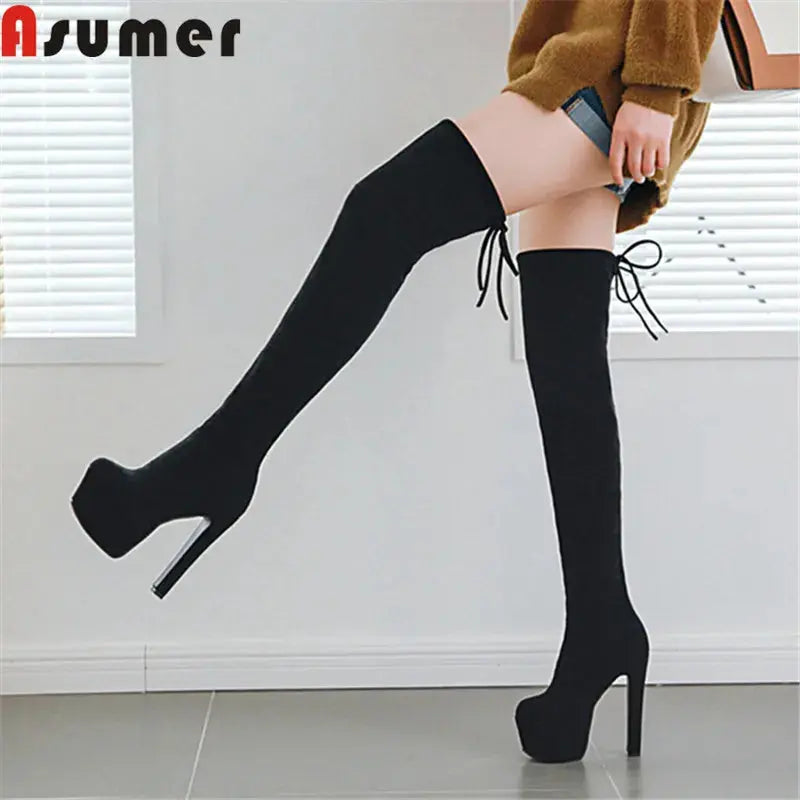 Black thigh-high boots with plush lining and high heels for a confident look.