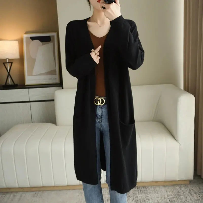 Cashmere Embrace cardigan in a warm autumn landscape, perfect for seasonal wear.