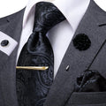 Stylish paisley tie set arranged on a wooden surface.