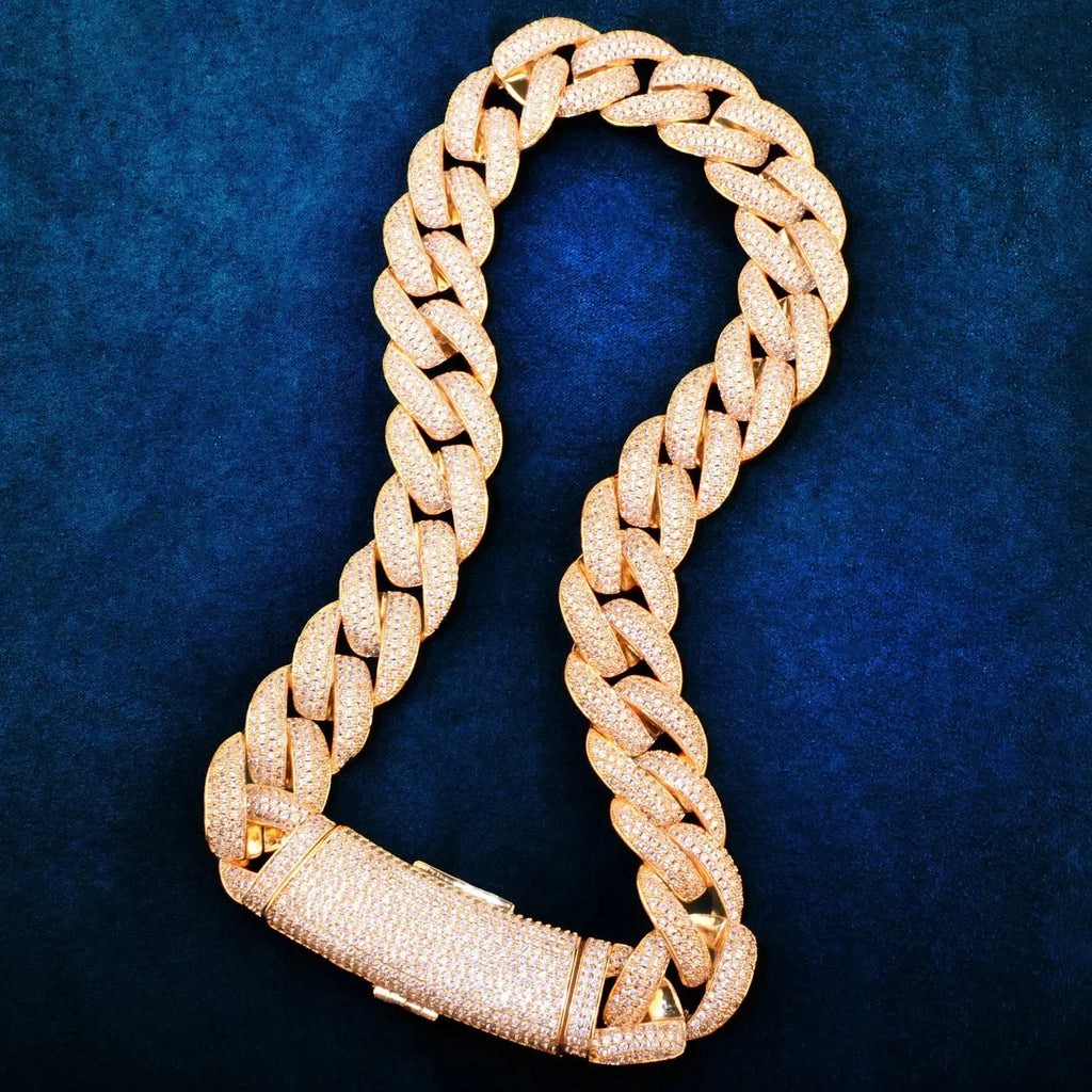 Gold Cuban chain necklace displayed on a black background, emphasizing its luxury appeal.