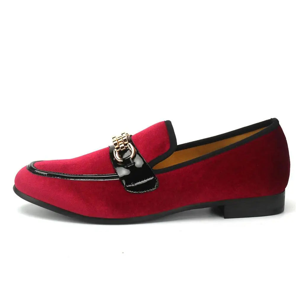 Red velvet loafers paired with modern men's fashion ensemble.