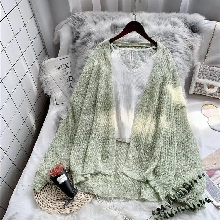 Breeze Whisper Cardigan in a light color, ideal for transitional weather and sun protection.
