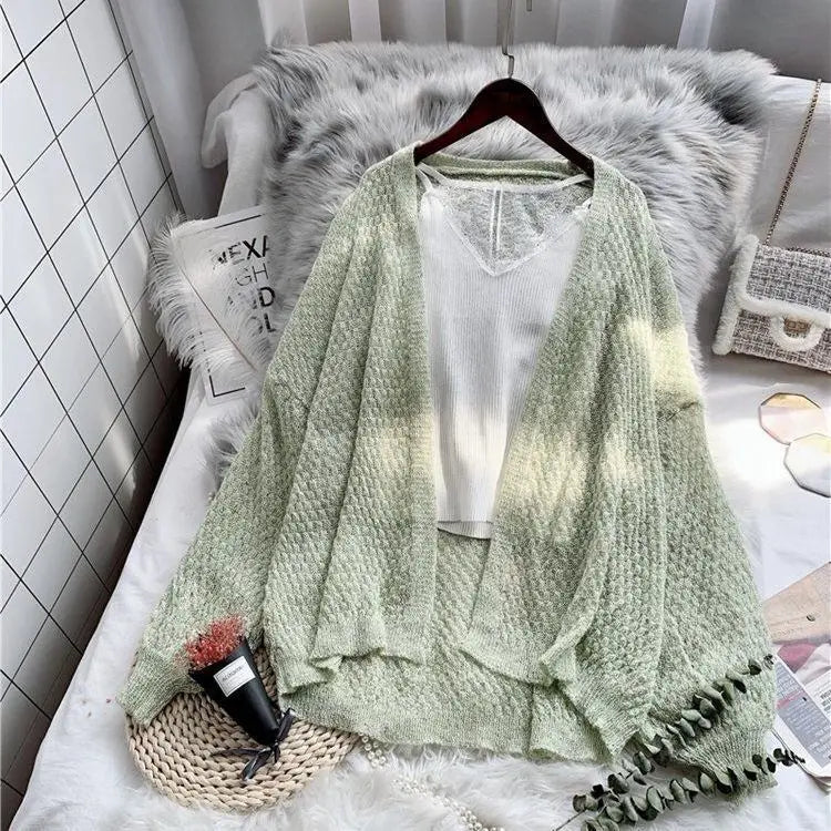 Breeze Whisper Cardigan in a light color, ideal for transitional weather and sun protection.