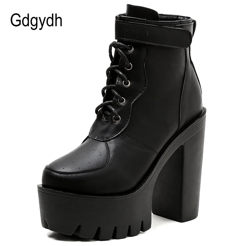 Side view of black platform ankle boots with thick square heel and lug sole tread