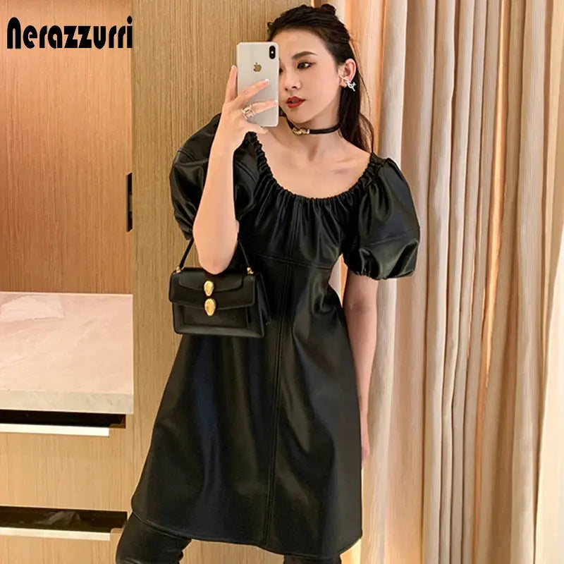 Back view of luxe lantern sleeve leather dress highlighting the pullover design.
