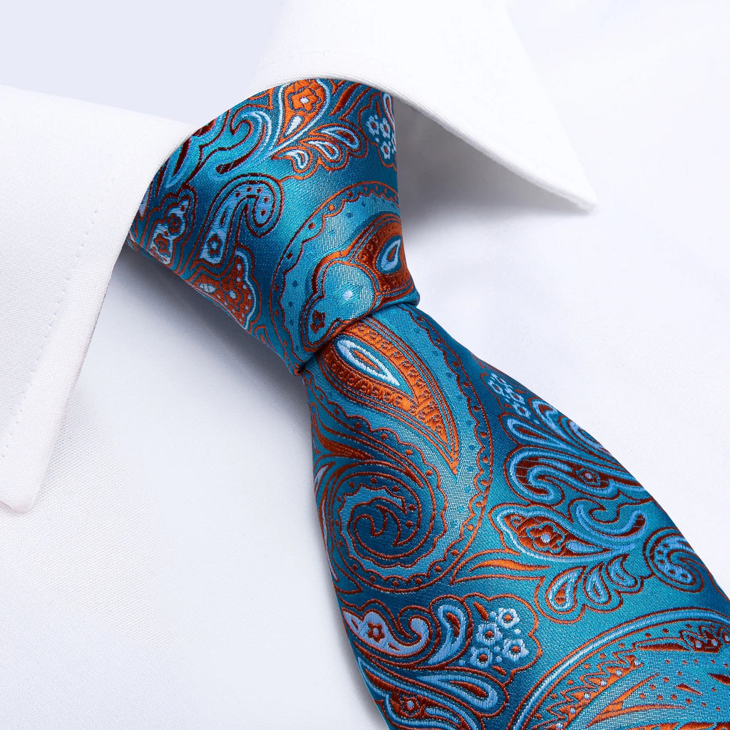 Blue and red paisley silk tie with coordinating pocket square on white background