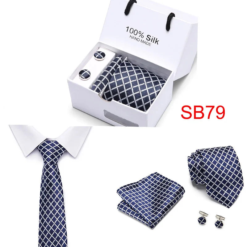 Red silk tie presented in a protective gift box with accessories.