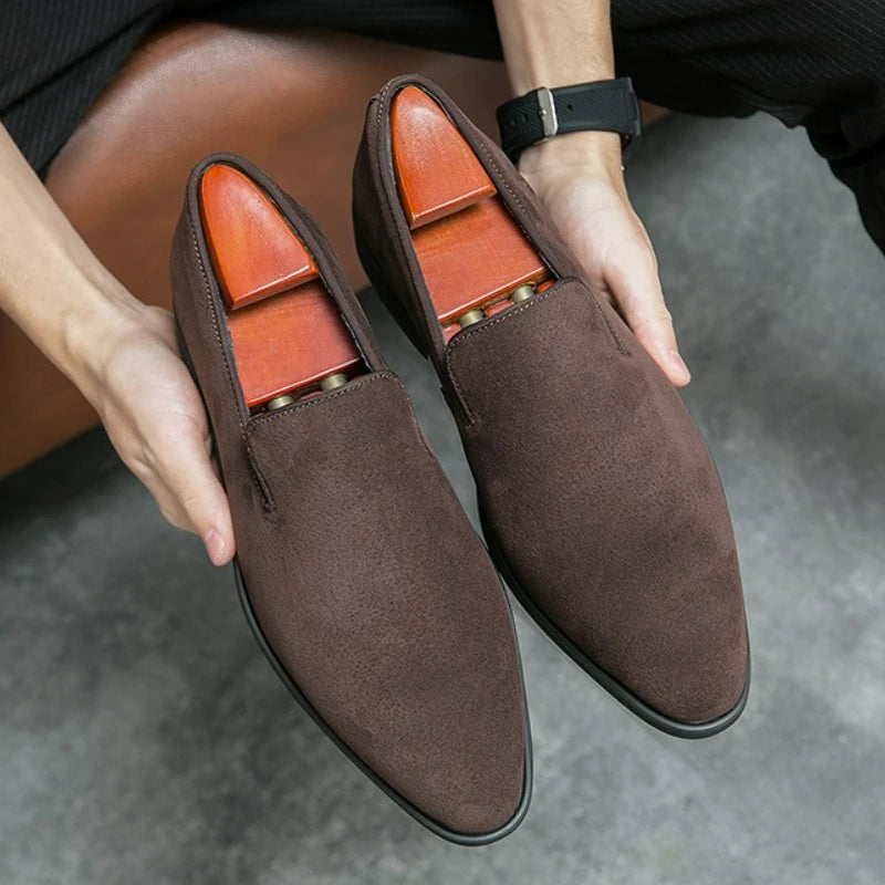 Classic suede loafers with modern pointed silhouette and eye-catching red sole accent