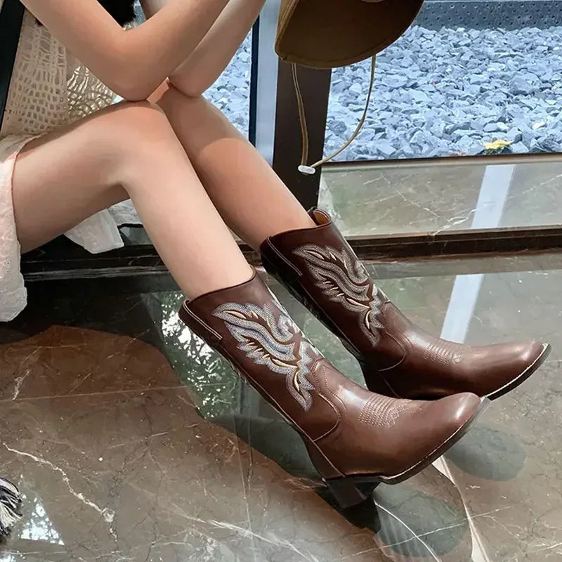 Women's mid-calf cowboy boots featuring hand-inspired embroidery and slip-on design