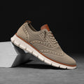 Close-up of breathable mesh wingtip sneakers showing detailed brogue pattern and flexible slip-on design