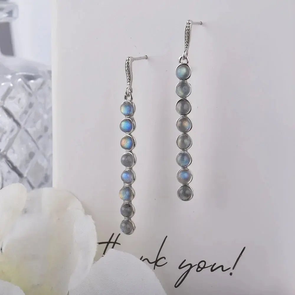 Stylish presentation of silver earrings in a gift box with a silver cleaning cloth for safekeeping.