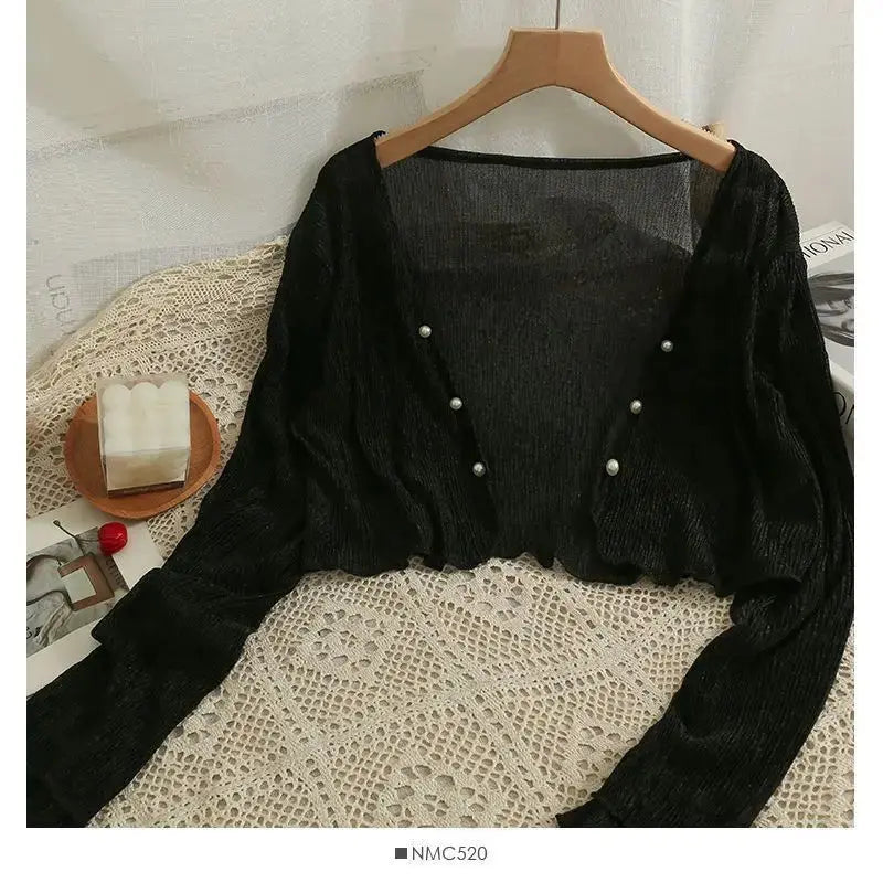 Summer Breeze Cardigan displayed on a hanger, emphasizing its soft color palette.