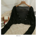 Summer Breeze Cardigan displayed on a hanger, emphasizing its soft color palette.