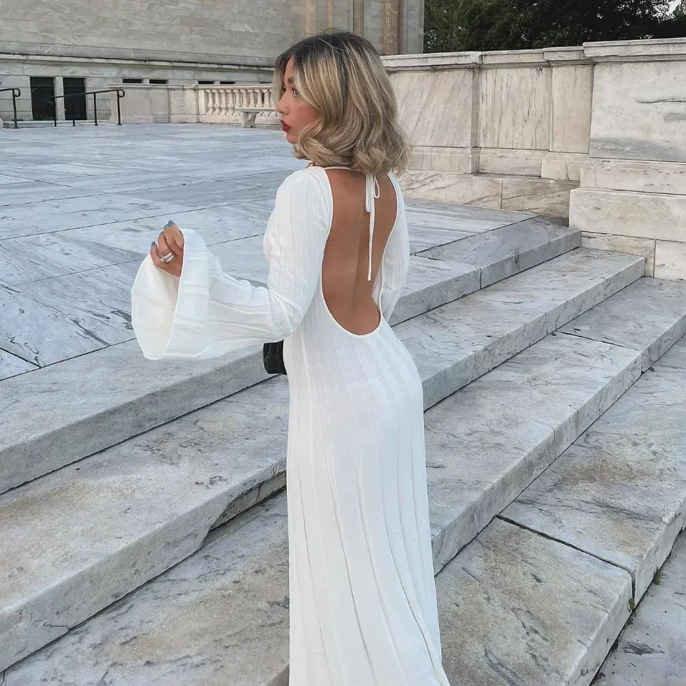Backless white knitted maxi dress with long sleeves and bodycon silhouette.