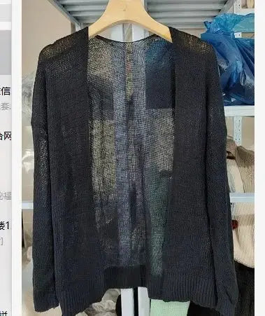 Summer Breeze Knit Cardigan draped over a beach chair, perfect for a relaxed summer vibe.