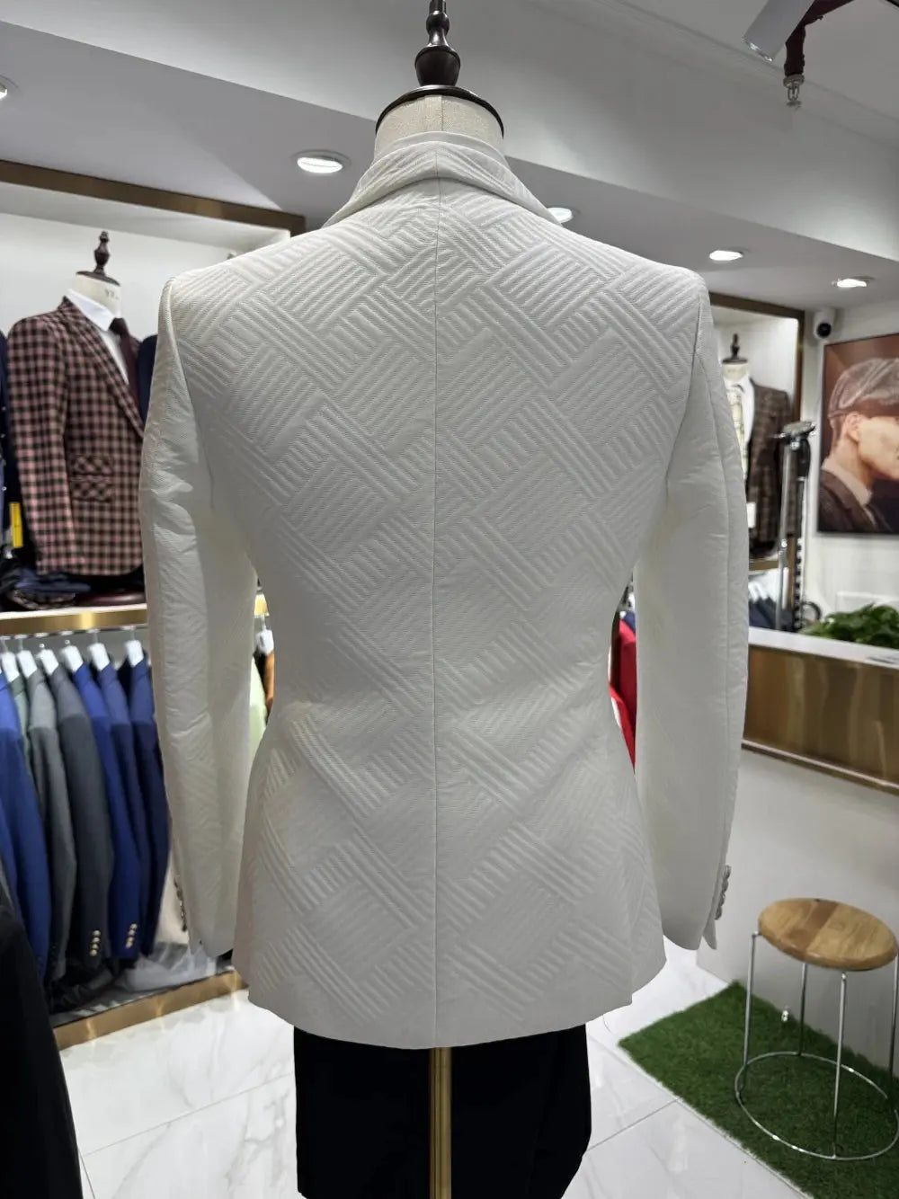 Close-up of luxurious jacquard fabric in a sophisticated white ensemble.