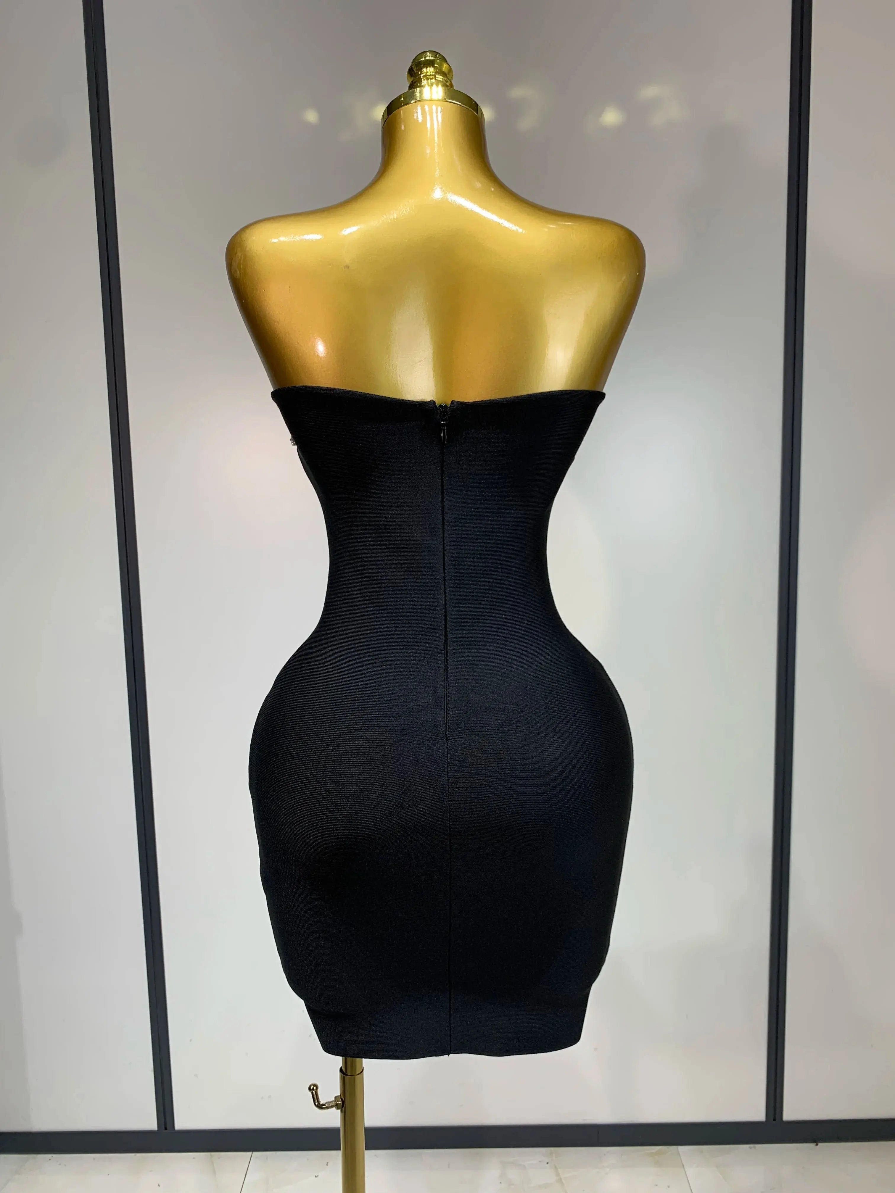 Back view of the strapless mini dress featuring a seamless zip closure for easy wear.