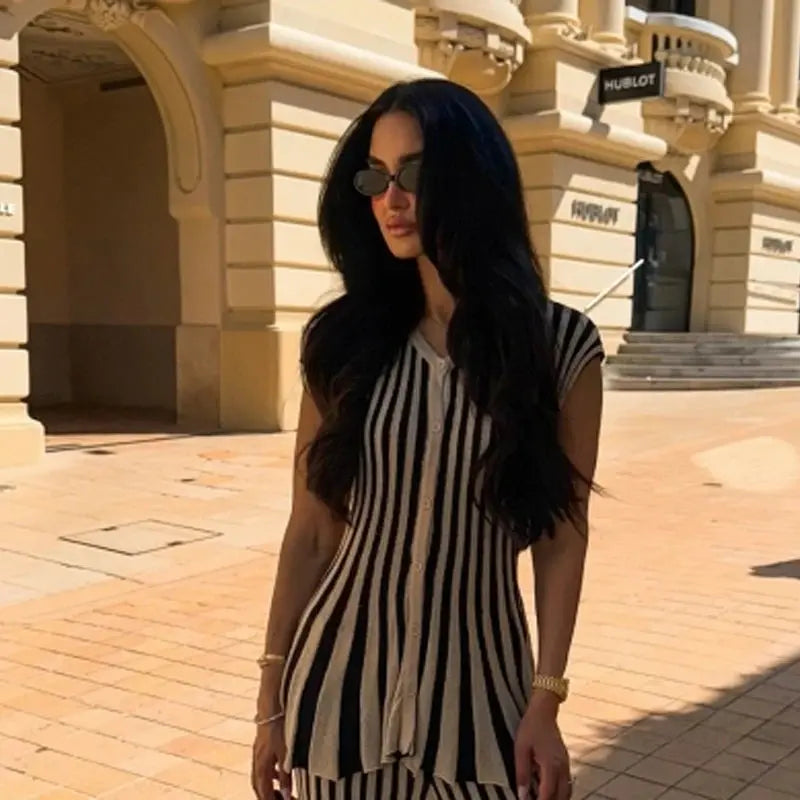 Model showcasing the versatile fashion of the striped knit suit in a professional setting.