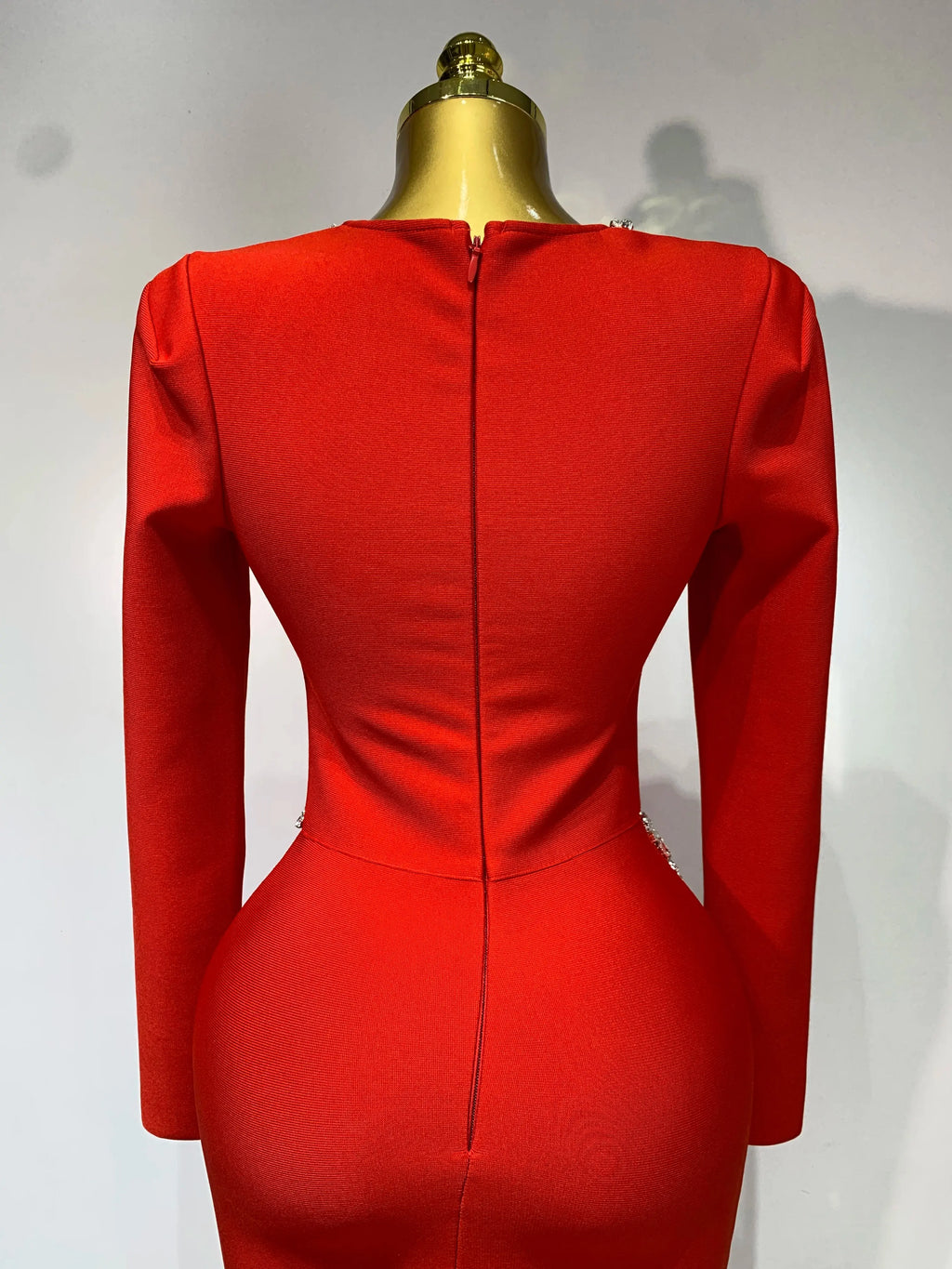 Model wearing the Captivate the Room red dress, exuding confidence at a glamorous gathering.