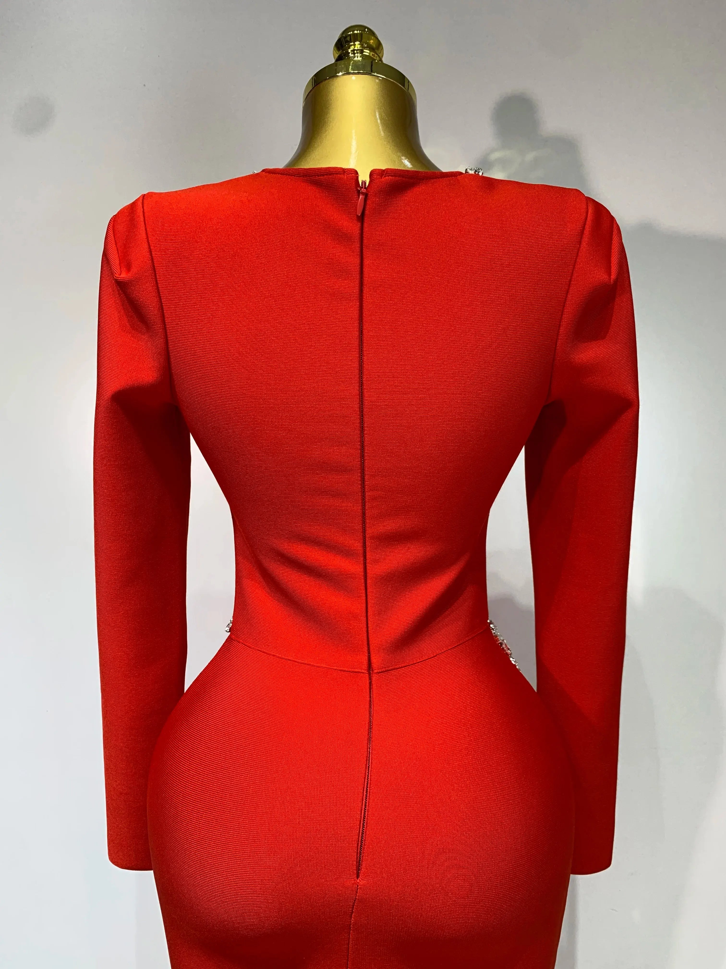 Model wearing the Captivate the Room red dress, exuding confidence at a glamorous gathering.