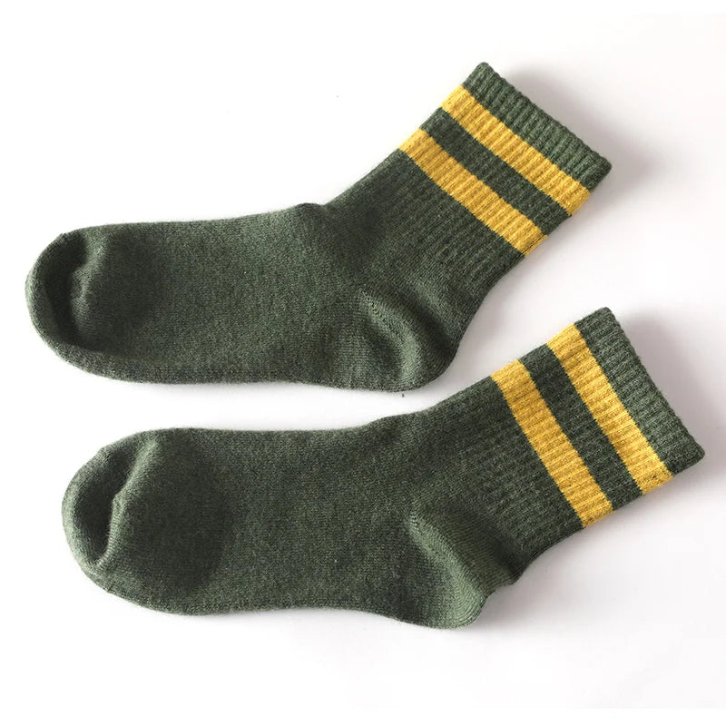 Cashmere socks on a wooden surface, emphasizing their luxurious feel and craftsmanship.
