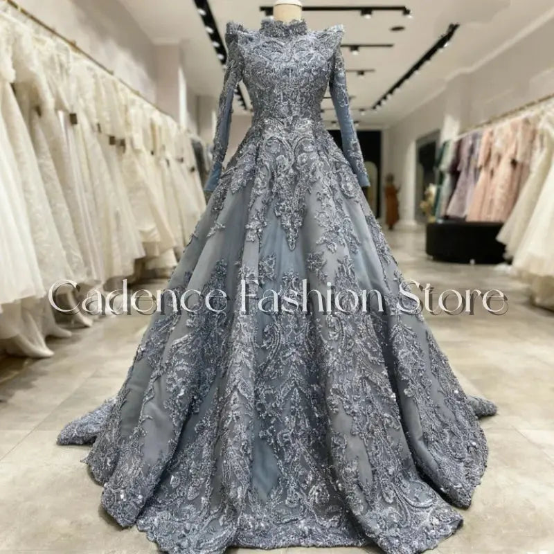 Luxurious lace gown with hand-beaded high neckline and full sleeves in elegant floor-length design.