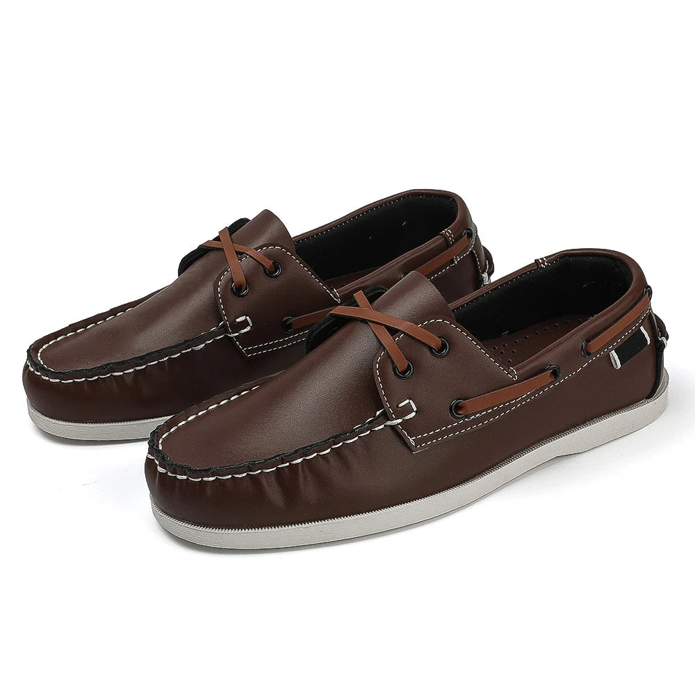 Detail shot of cross-tied accent on sophisticated men's apron toe loafers