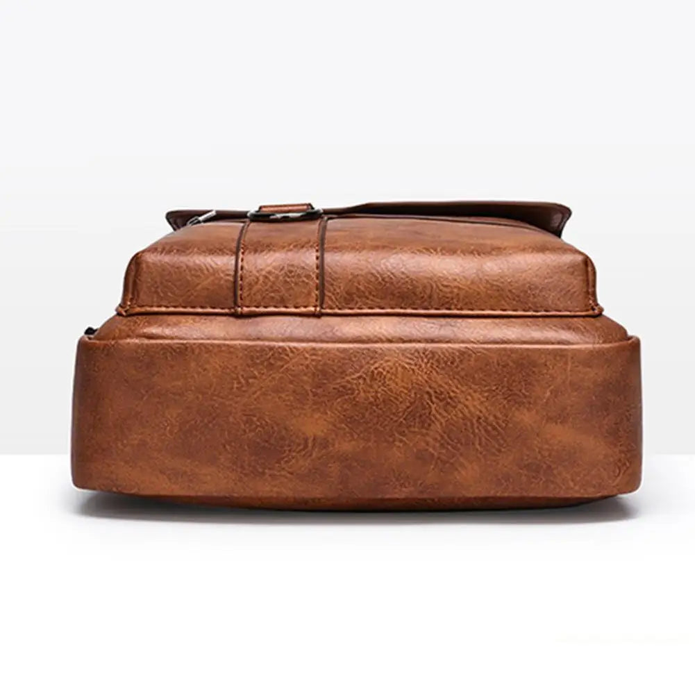 Detail shot of adjustable shoulder strap hardware on vintage leather crossbody bag