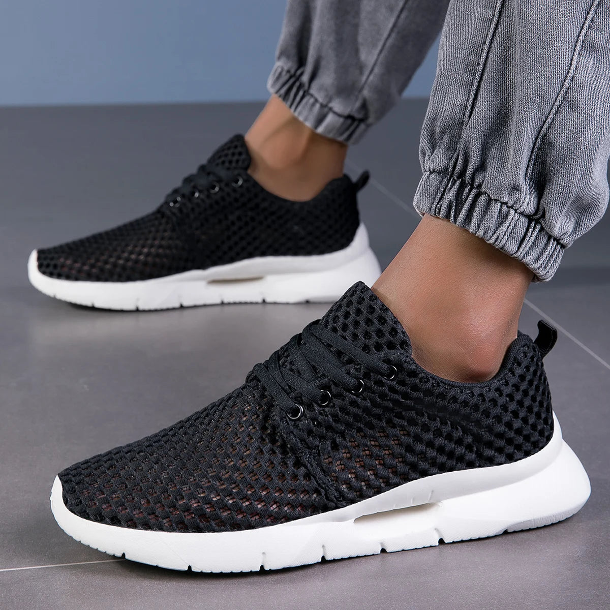 Pair of men's breathable mesh loafers displaying sleek design and easy slip-on construction