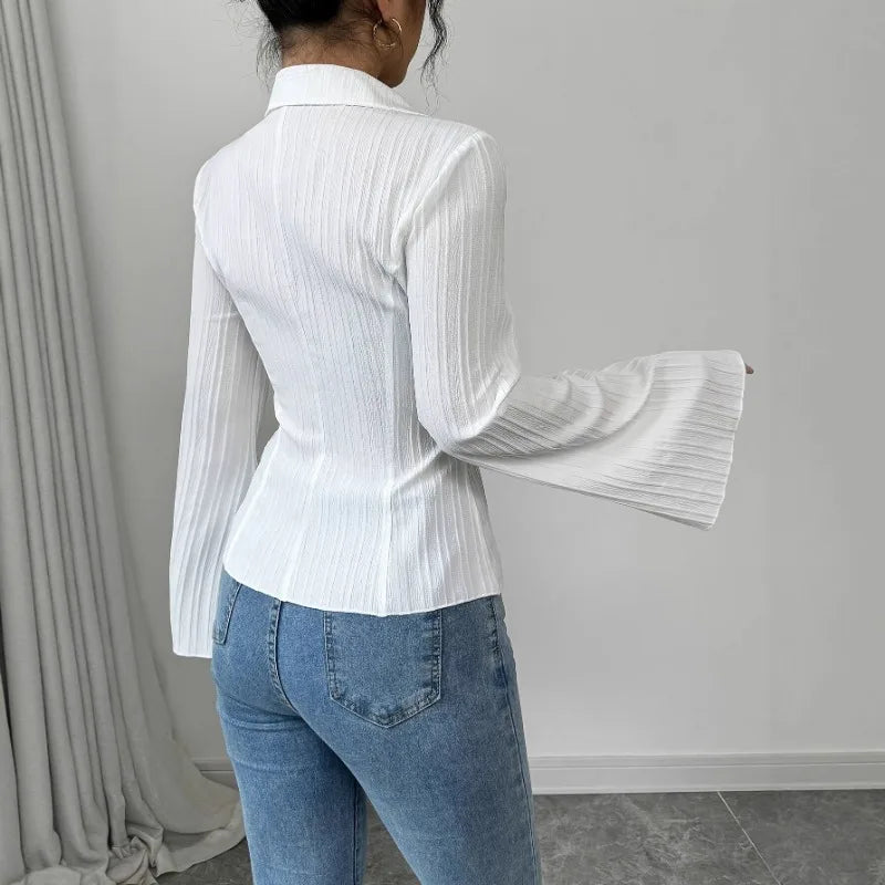 Ribbed button-front blouse with turn-down collar and dramatic flared sleeves styled with trousers