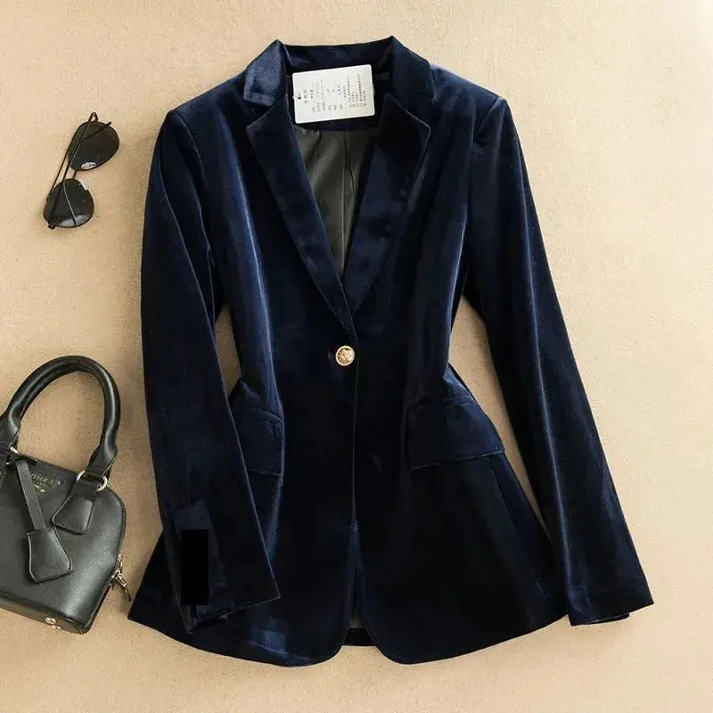 Close-up of golden velvet texture on a stylish women's blazer.