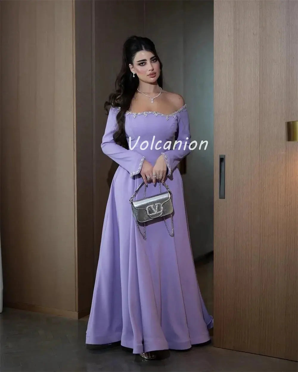 Close-up of the soft jersey material of the off-shoulder gown, highlighting its luxurious drape and comfort.